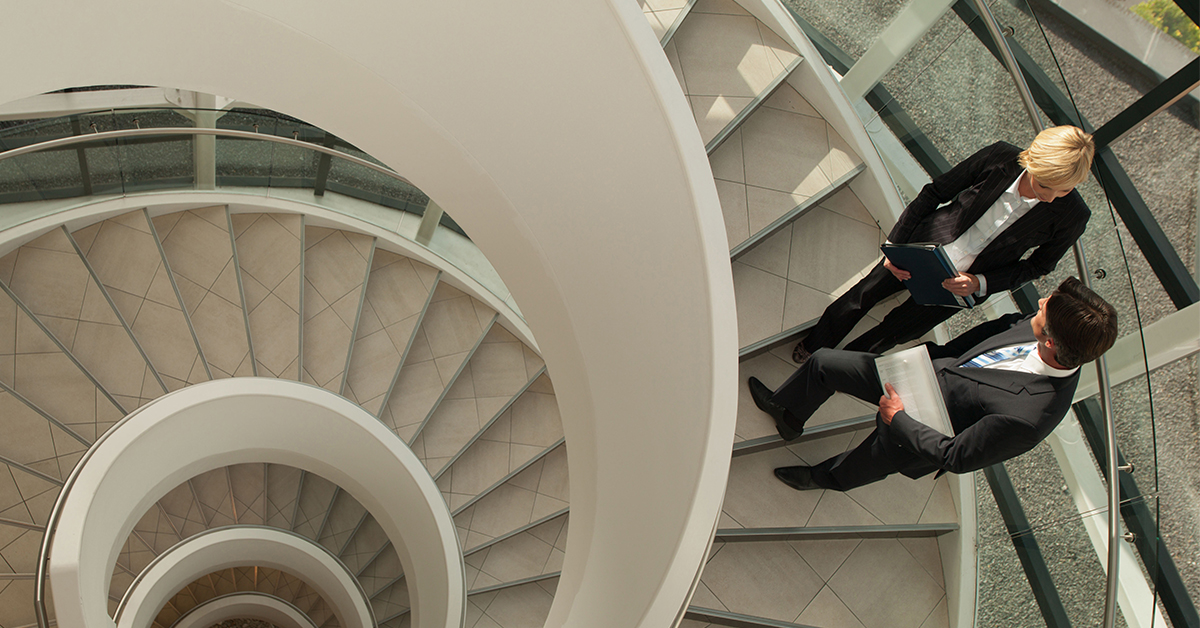 The modern architecture of the building features an abstract spiral staircase, showcasing innovative interior design.