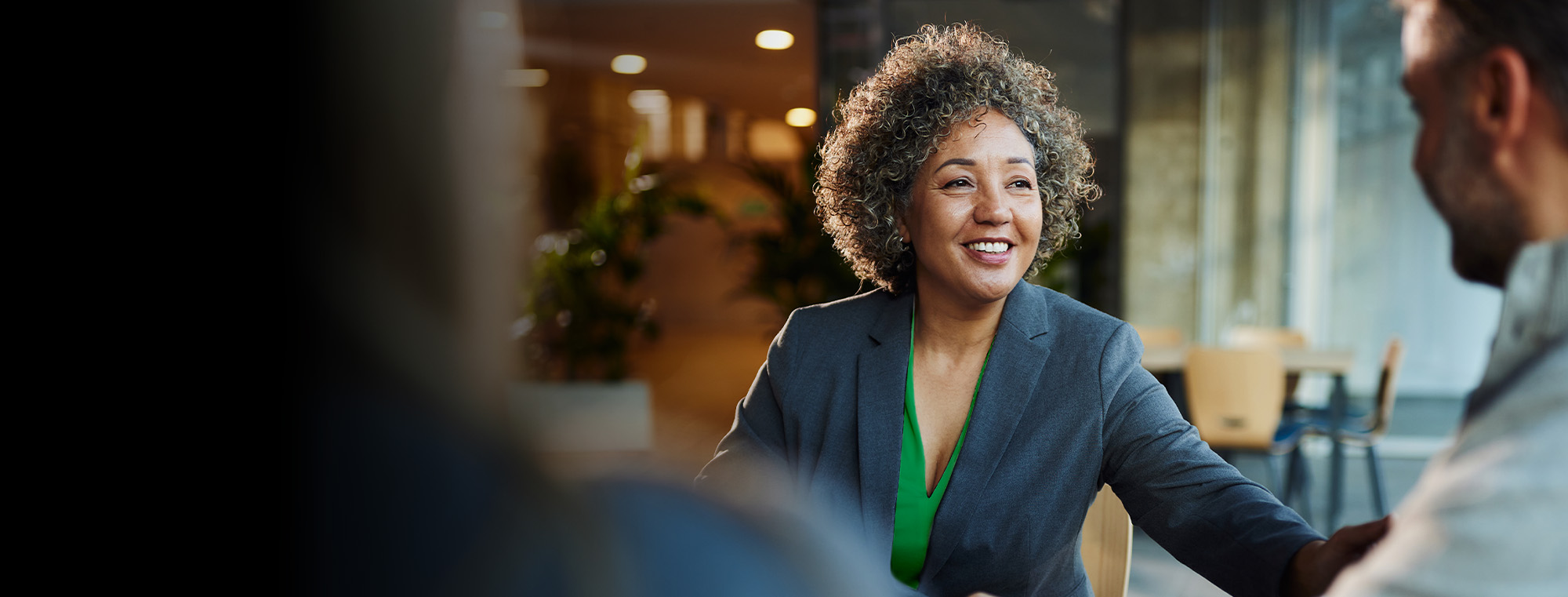 A professional portrait showcasing a young female entrepreneur confidently navigating her business landscape.